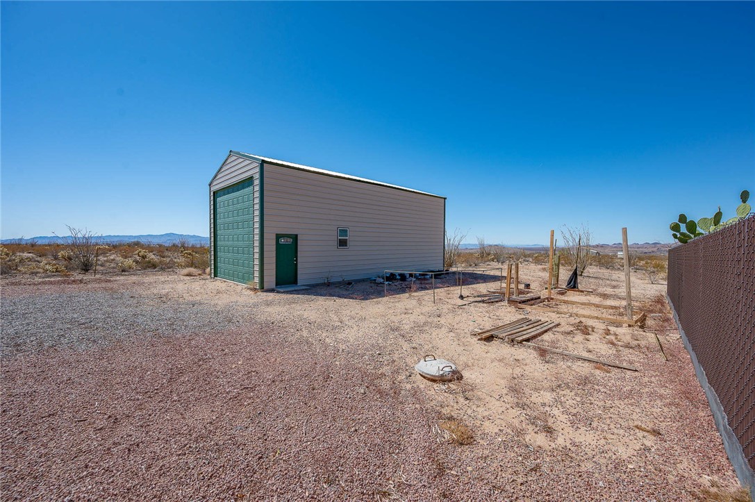 14105 Cactus Road Yucca, AZ 86438 - Photo 38 of 47 a view of a dry yard with wooden fence