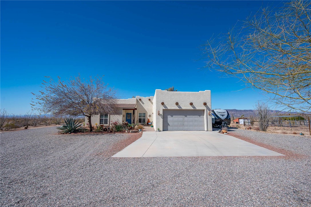 14105 Cactus Road Yucca, AZ 86438 - Photo 5 of 47 a view of a house with a outdoor space