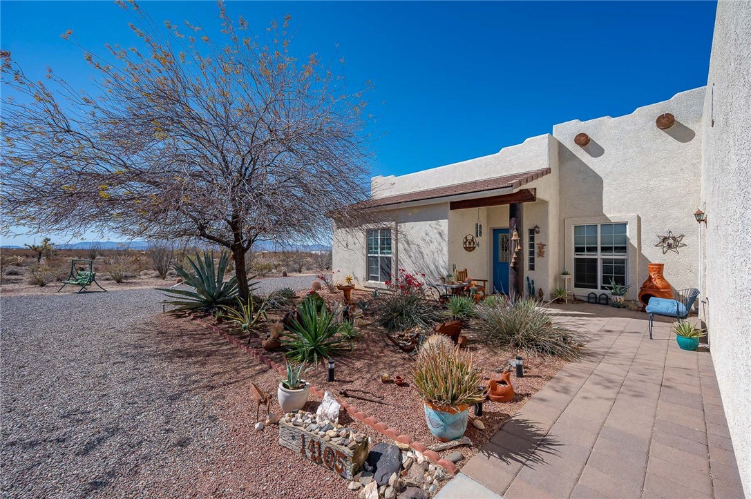 14105 Cactus Road Yucca, AZ 86438 - Photo 8 of 47 a front view of a house with garden