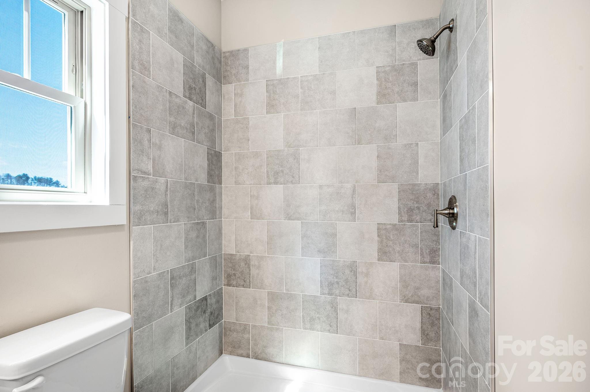 79 Wheeler Road Weaverville, NC 28787 - Photo 17 of 33 a bathroom with a shower and a toilet
