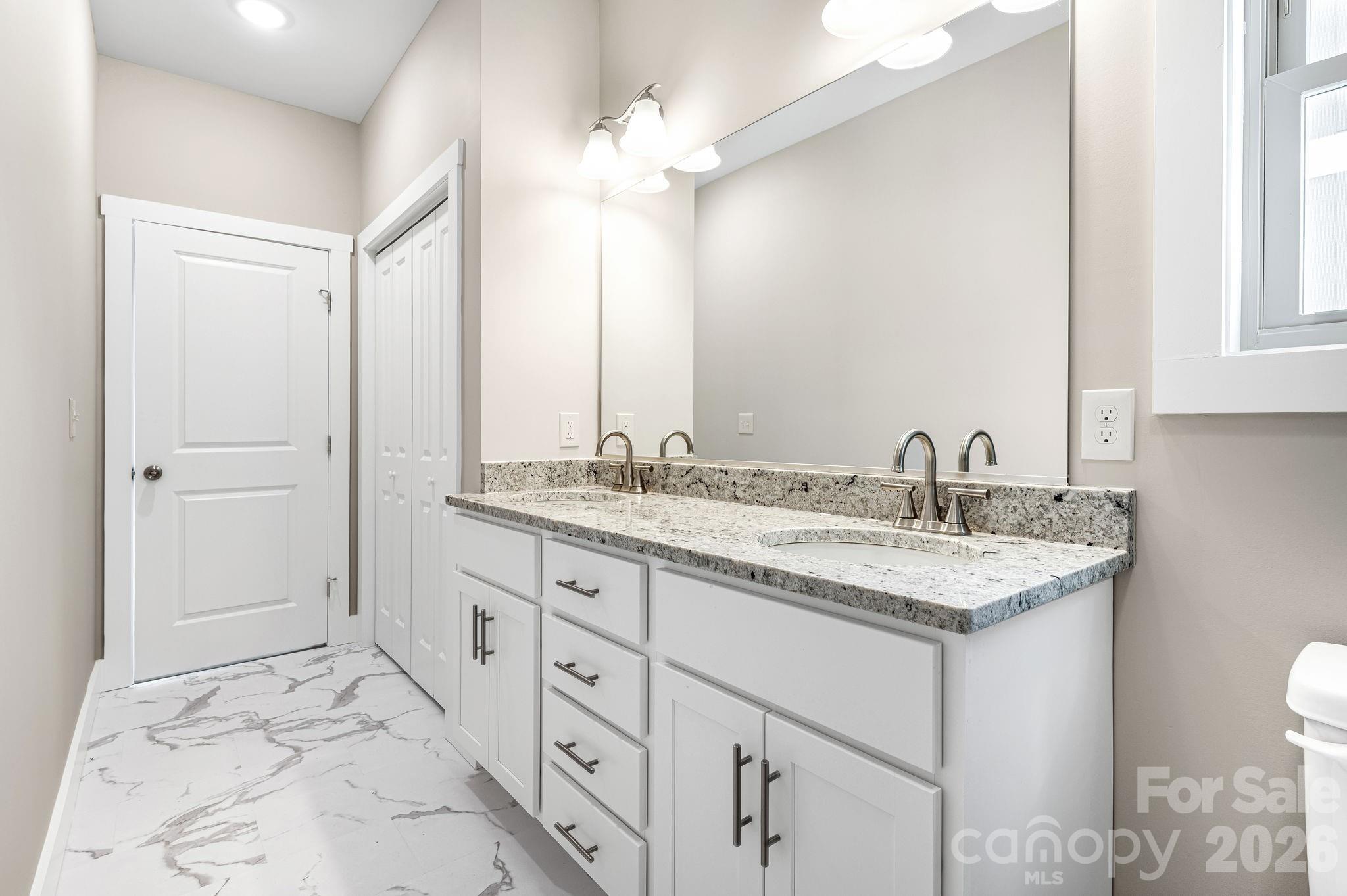 79 Wheeler Road Weaverville, NC 28787 - Photo 18 of 33 a bathroom with a sink and a mirror