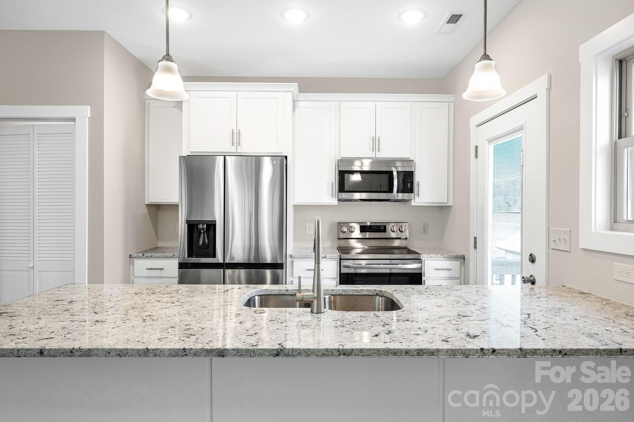 79 Wheeler Road Weaverville, NC 28787 - Photo 7 of 33 a kitchen with stainless steel appliances granite countertop a sink refrigerator and microwave