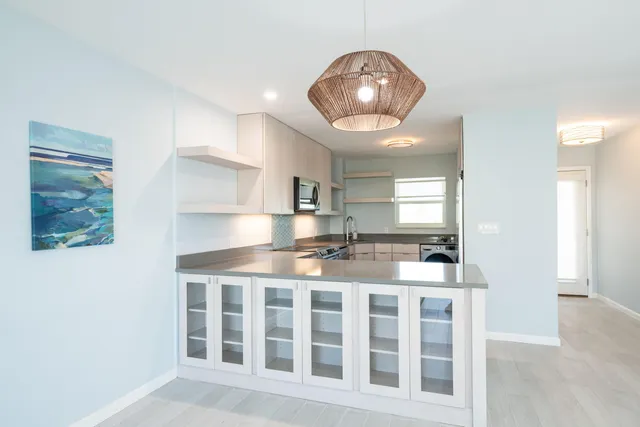 a kitchen with stainless steel appliances granite countertop a stove and cabinets