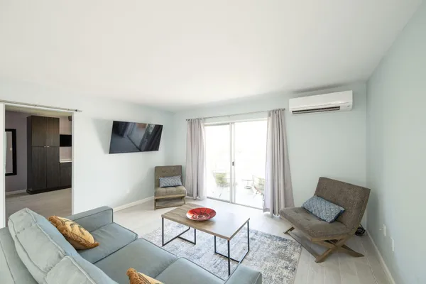 a living room with a couch and chandelier