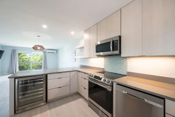 a view of a kitchen with a sink a refrigerator and window