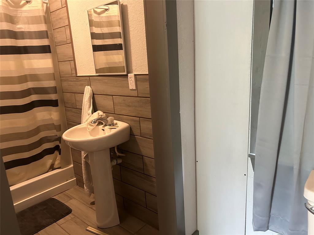 190 Private Road Groesbeck, TX 76642 - Photo 12 of 25 a bathroom with a sink and a mirror