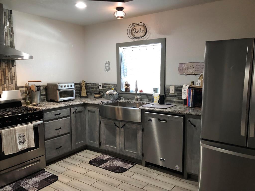 190 Private Road Groesbeck, TX 76642 - Photo 3 of 25 a kitchen with stainless steel appliances granite countertop a sink stove and refrigerator