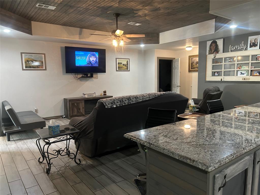 190 Private Road Groesbeck, TX 76642 - Photo 5 of 25 a kitchen with a table chairs and a refrigerator