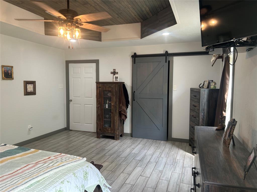 190 Private Road Groesbeck, TX 76642 - Photo 8 of 25 a bedroom with a bed and a refrigerator