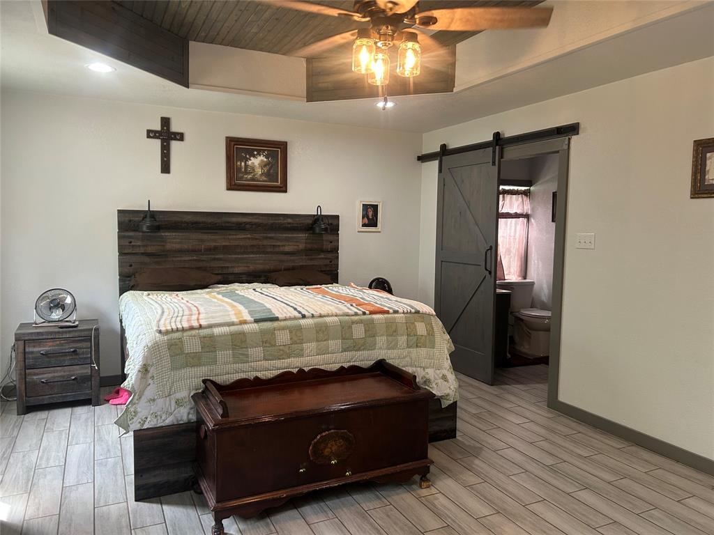 190 Private Road Groesbeck, TX 76642 - Photo 9 of 25 a bed sitting in a bedroom next to a bathroom