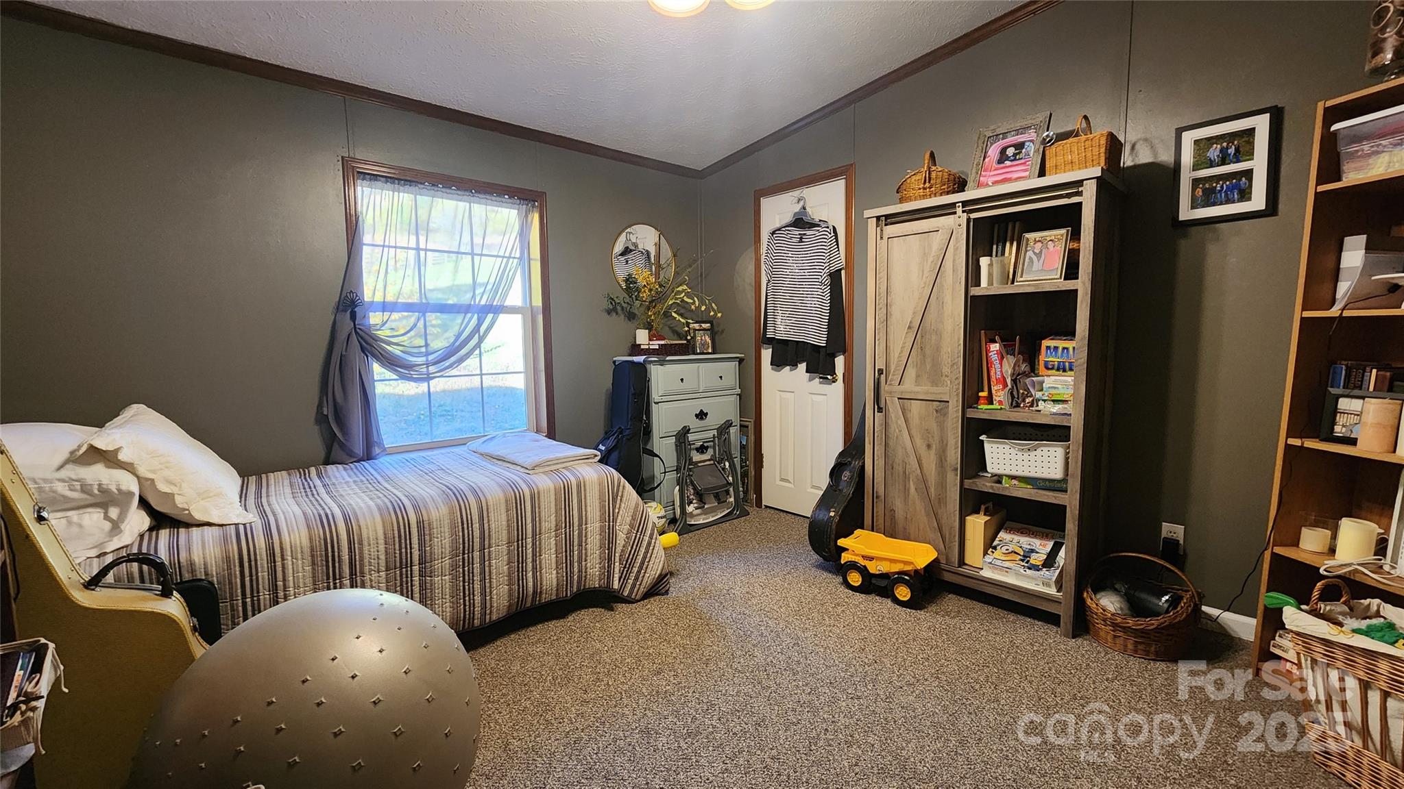 141 Hungry Creek Road Canton, NC 28716 - Photo 13 of 38 a bedroom with bed and a large window