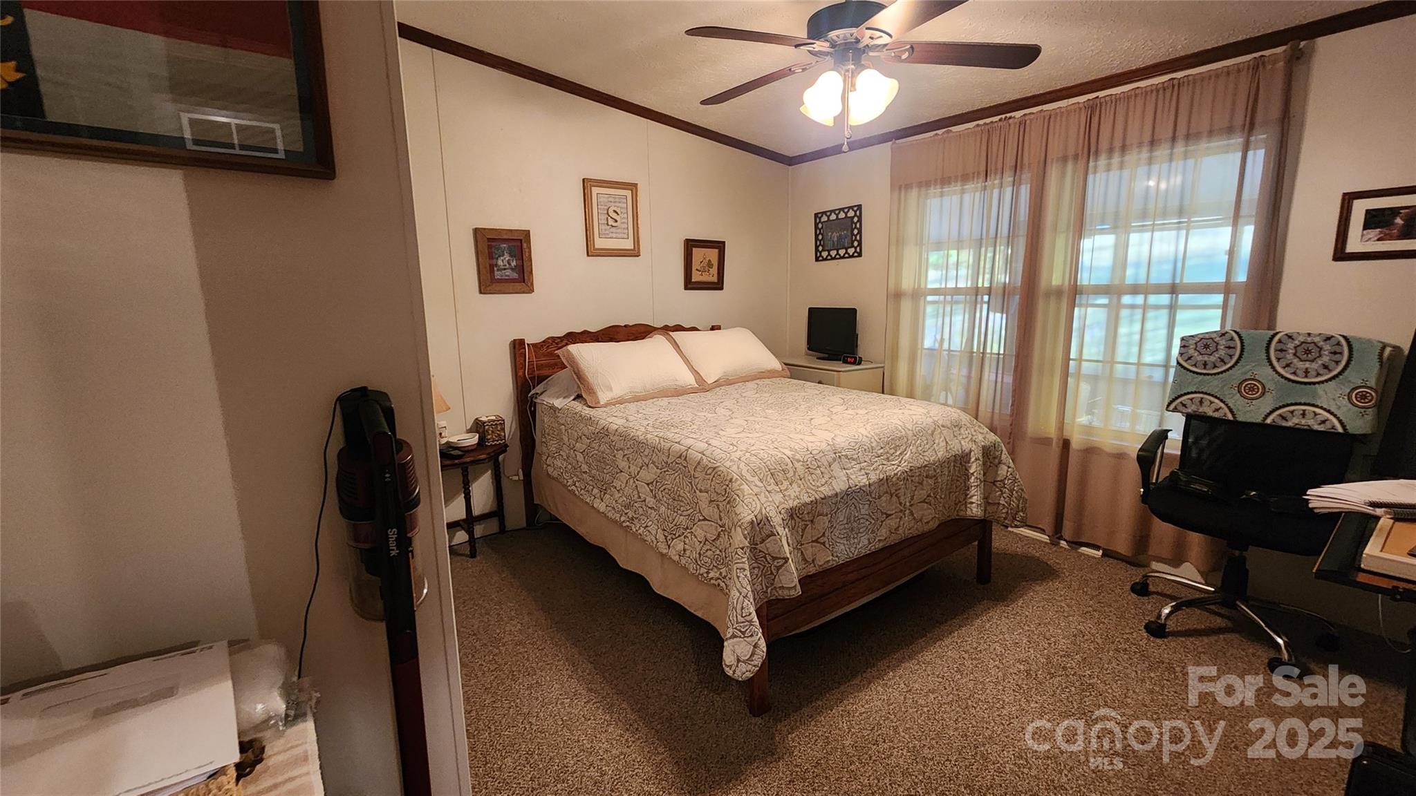 141 Hungry Creek Road Canton, NC 28716 - Photo 14 of 38 a bedroom with a bed and a chandelier