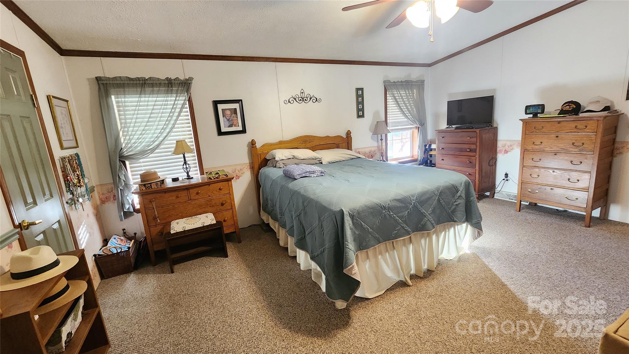 141 Hungry Creek Road Canton, NC 28716 - Photo 16 of 38 a bedroom with a bed and a flat tv screen on dresser