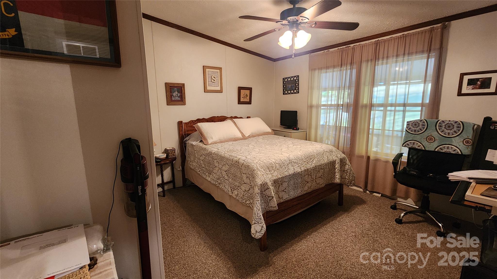141 Hungry Creek Road Canton, NC 28716 - Photo 18 of 38 a bedroom with a bed and a chandelier