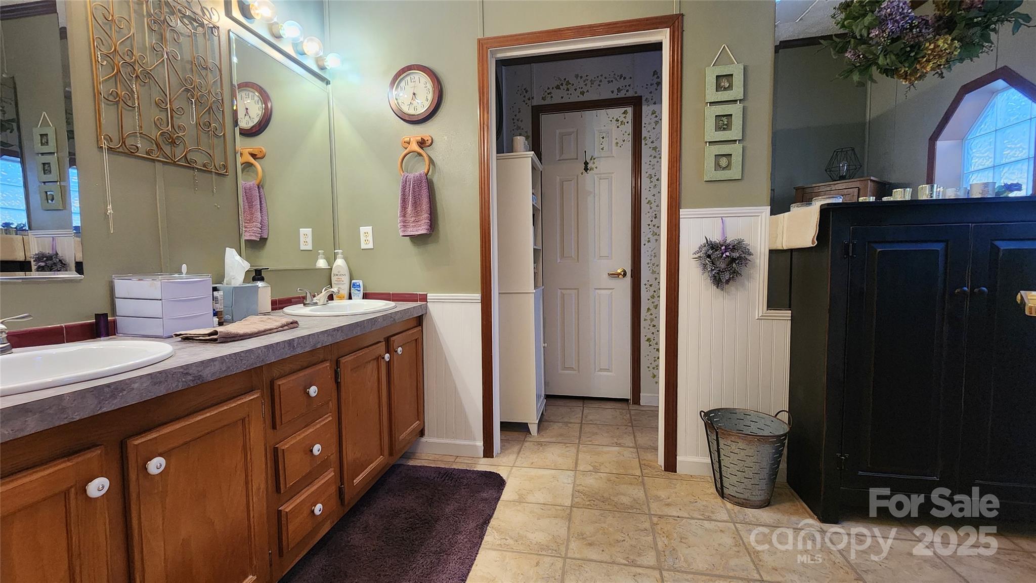 141 Hungry Creek Road Canton, NC 28716 - Photo 21 of 38 a spacious bathroom with a double vanity sink and a mirror