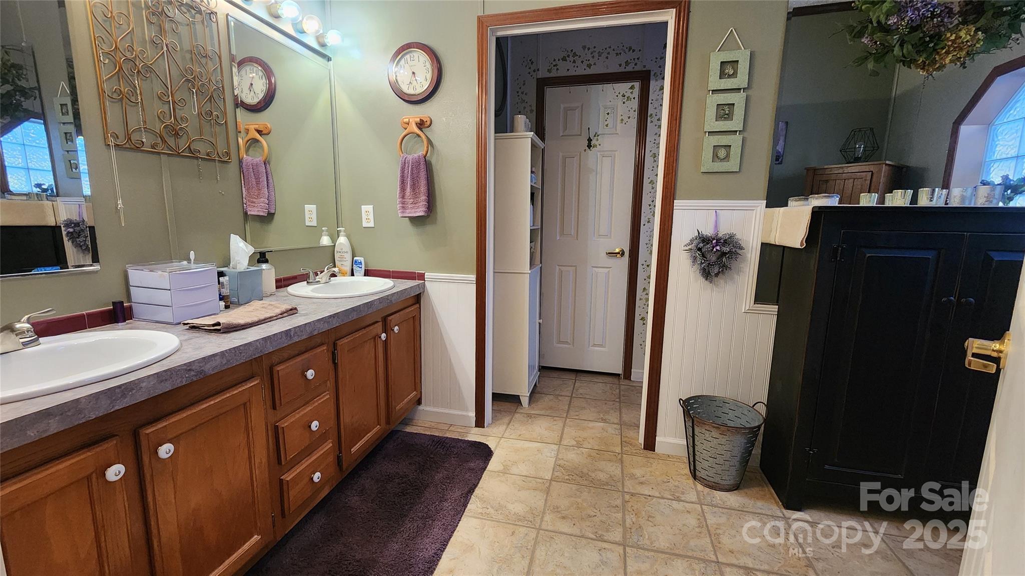 141 Hungry Creek Road Canton, NC 28716 - Photo 22 of 38 a spacious bathroom with a double vanity sink and a mirror