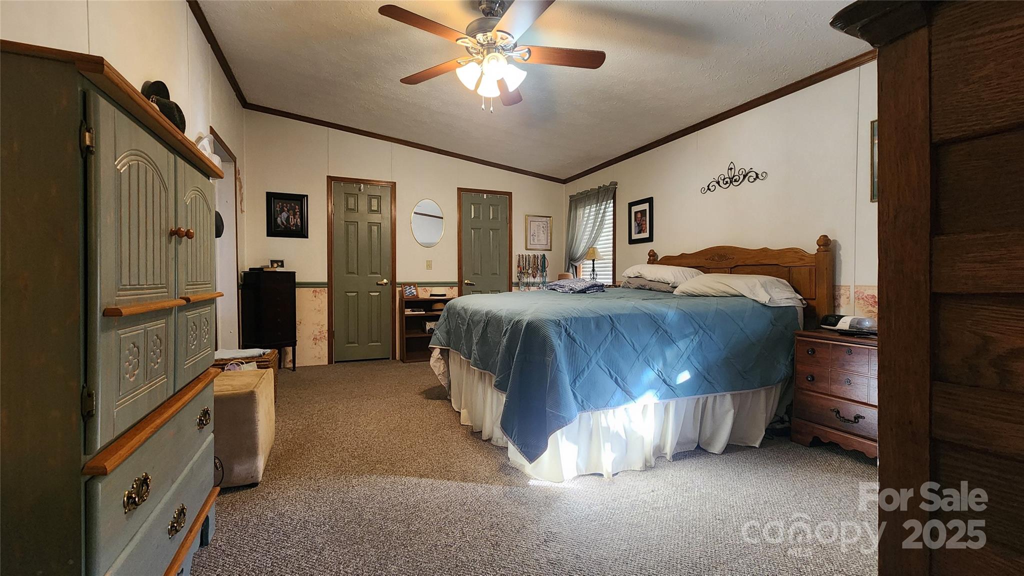 141 Hungry Creek Road Canton, NC 28716 - Photo 24 of 38 a bedroom with a bed and a chandelier