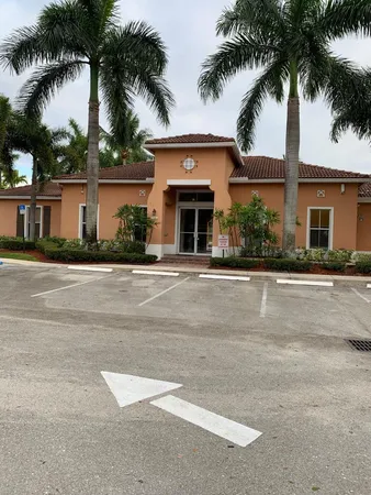 front view of house with a palm trees