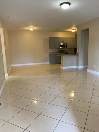 a view of a kitchen with a sink and cabinets