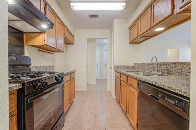 a kitchen with stainless steel appliances granite countertop a stove and a sink