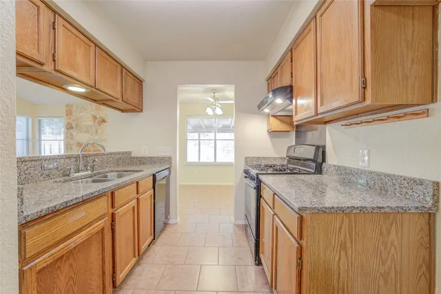 an empty room with a window and wooden floor