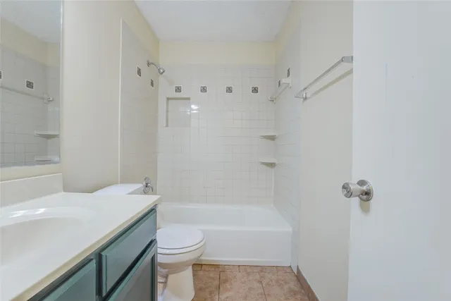 a view of an empty room with window and a bathroom