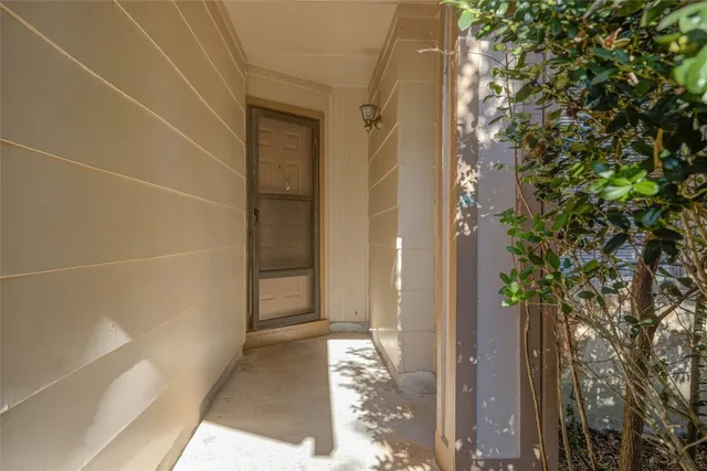 a view of a yard from a corridor