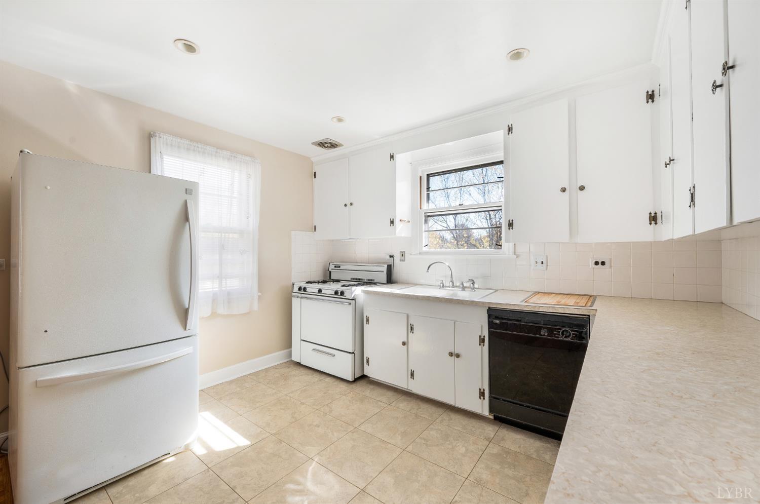 710 Riverside Drive Lynchburg, VA 24503 - Photo 24 of 53 a kitchen with white cabinets and white appliances