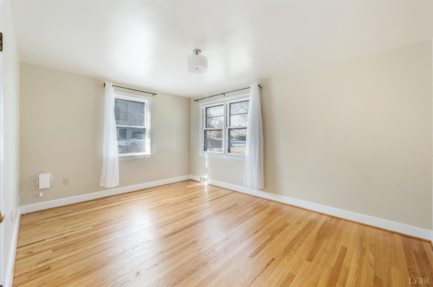 710 Riverside Drive Lynchburg, VA 24503 - Photo 8 of 53 an empty room with wooden floor and windows