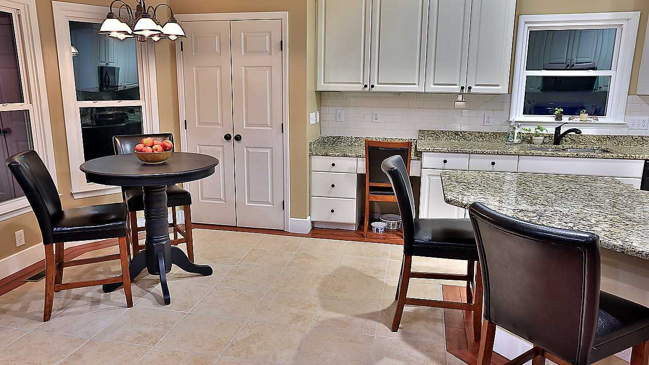 8536 Yucca Trail Raleigh, NC 27615 - Photo 14 of 23 Notice the tile floor is surrounded by hardwood - a unique detail! eat in kitchen