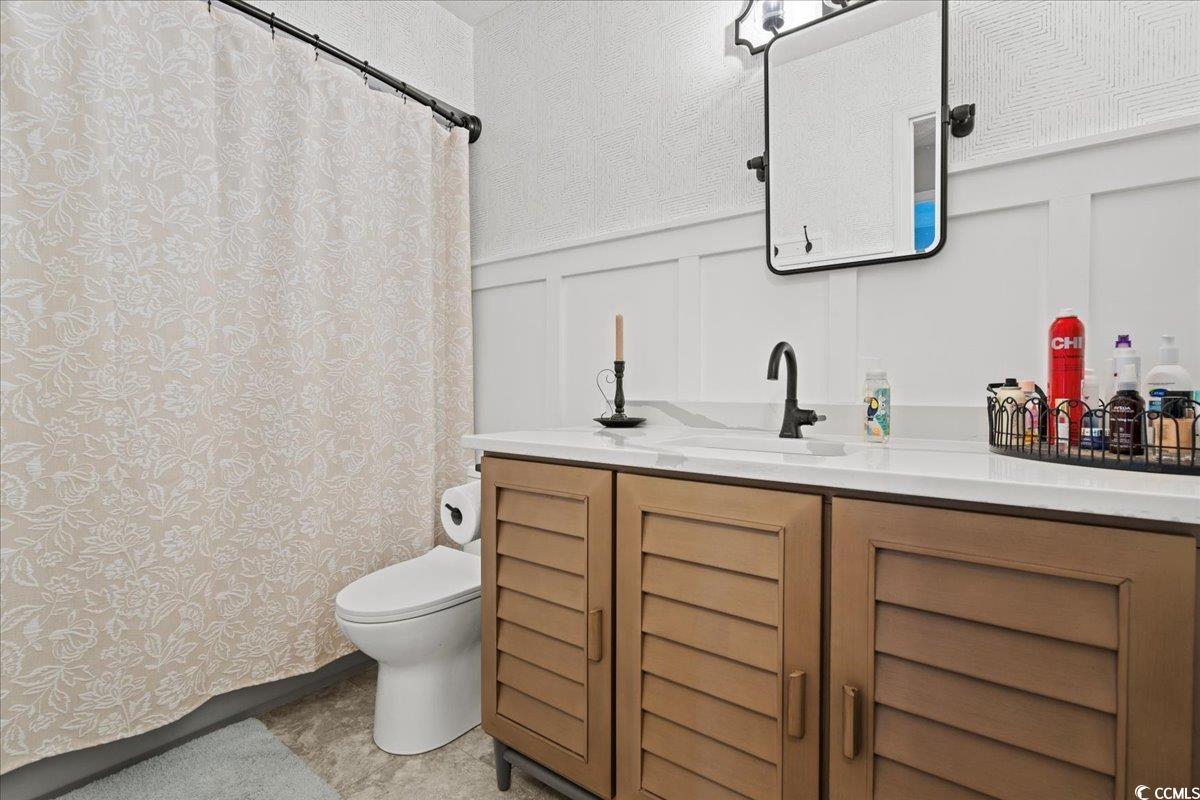 117 John Waites Court Georgetown, SC 29440 - Photo 21 of 40 Bathroom with a decorative wall, vanity, a shower with curtain, and wainscoting
