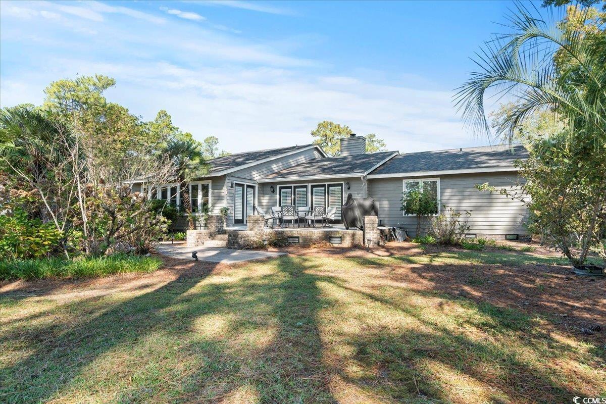 117 John Waites Court Georgetown, SC 29440 - Photo 34 of 40 Back of property with a patio, a chimney, and a yard