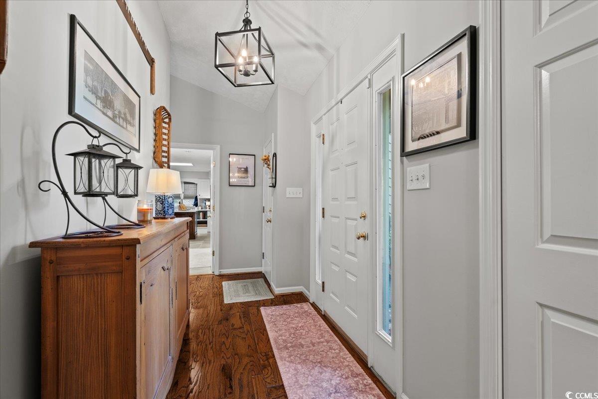 117 John Waites Court Georgetown, SC 29440 - Photo 4 of 40 Foyer featuring dark wood-style flooring, lofted ceiling, and a chandelier