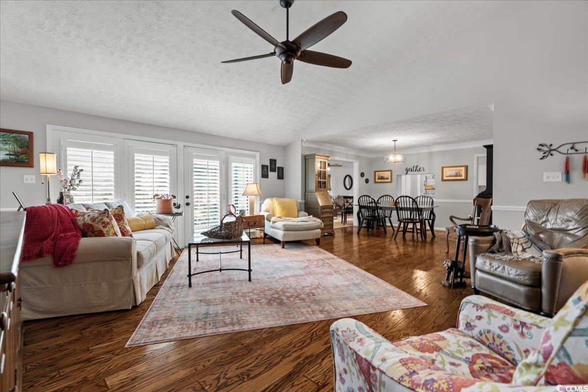 117 John Waites Court Georgetown, SC 29440 - Photo 6 of 40 Living area with a textured ceiling, lofted ceiling, dark wood-style flooring, and a ceiling fan