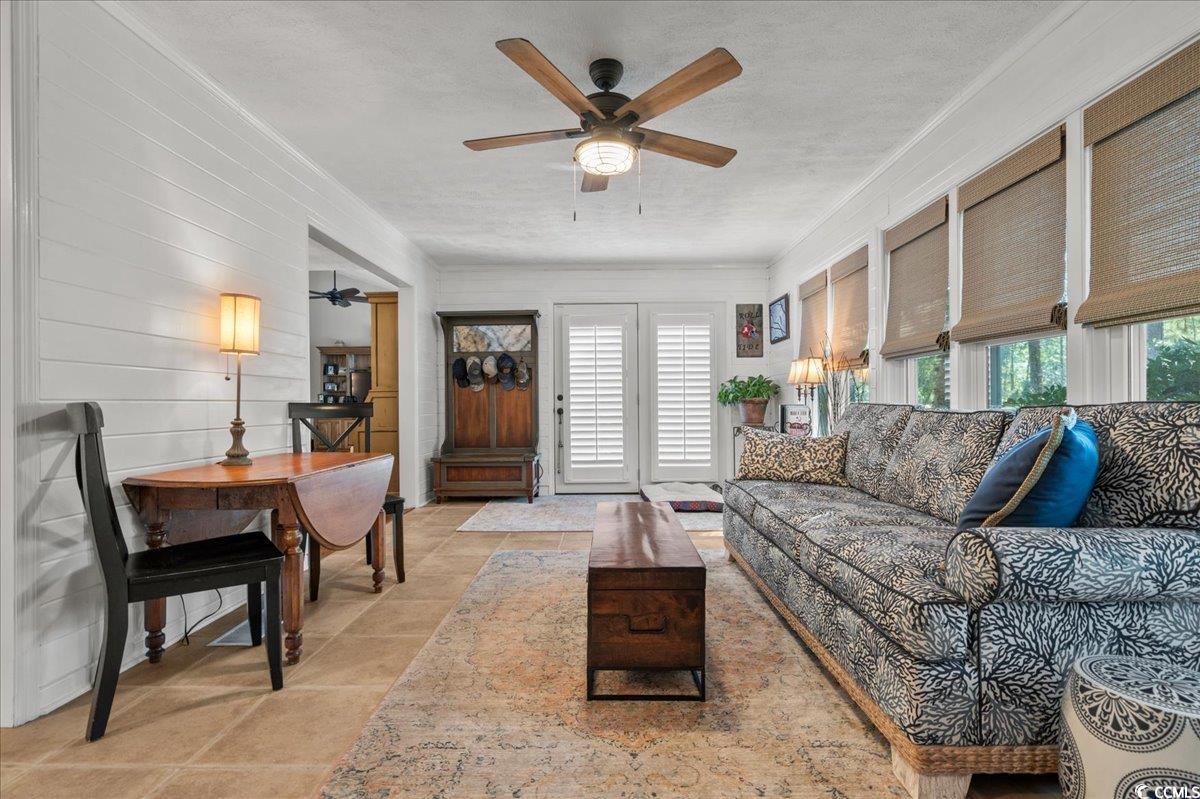 117 John Waites Court Georgetown, SC 29440 - Photo 10 of 40 Living room with a ceiling fan, crown molding, and a textured ceiling