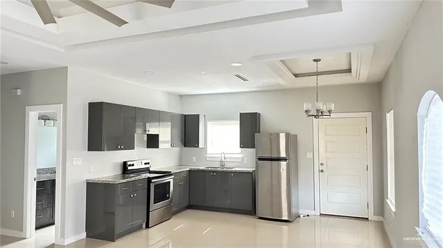 a large kitchen with cabinets and stainless steel appliances