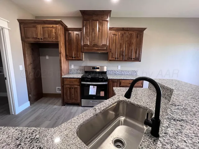 a kitchen with a sink and a stove top oven