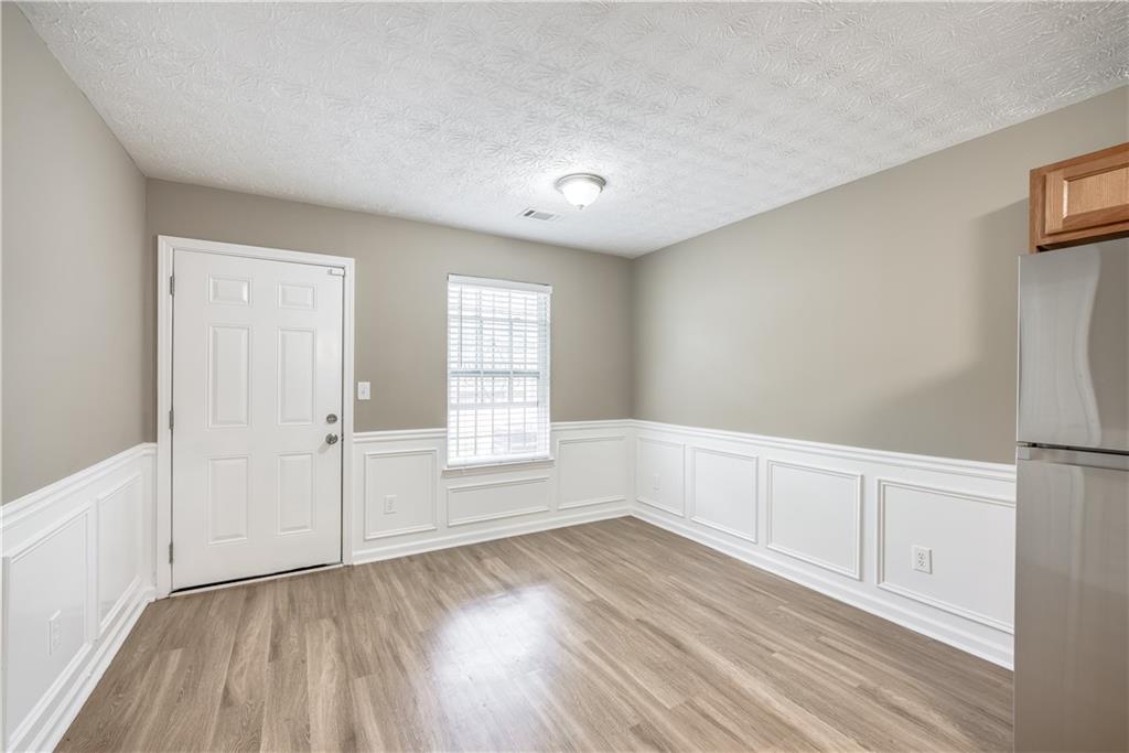 2913 Vining Ridge Terrace Decatur, GA 30034 - Photo 11 of 28 an empty room with wooden floor and windows