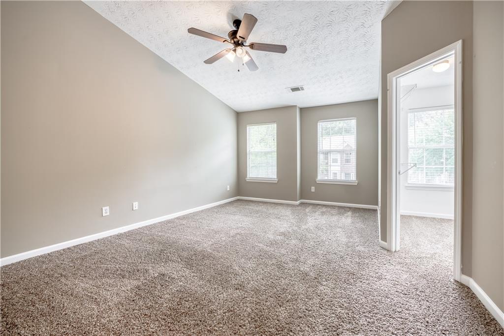2913 Vining Ridge Terrace Decatur, GA 30034 - Photo 17 of 28 an empty room with windows and chandelier fan