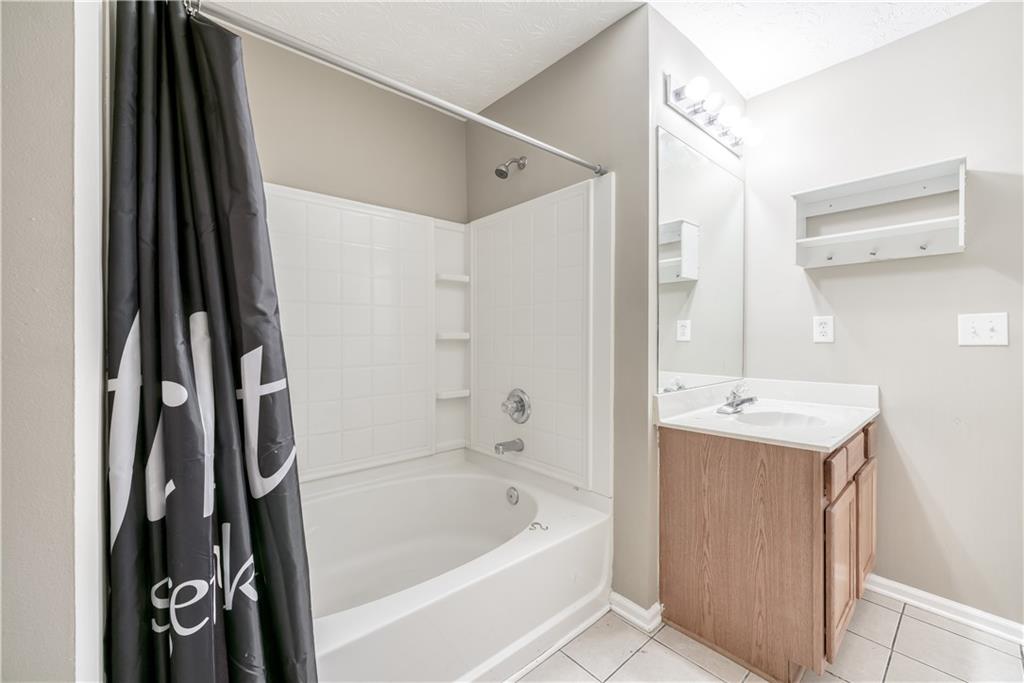 2913 Vining Ridge Terrace Decatur, GA 30034 - Photo 21 of 28 a bathroom with a bathtub a sink and a large mirror