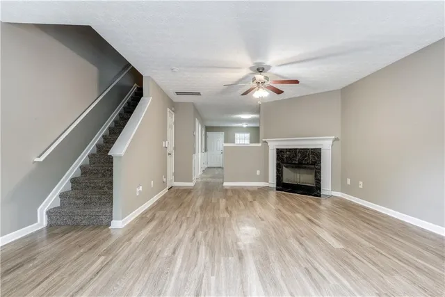 wooden floor in an empty room with a fireplace