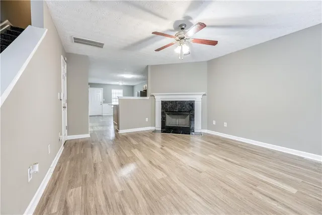 wooden floor in an empty room with a fireplace