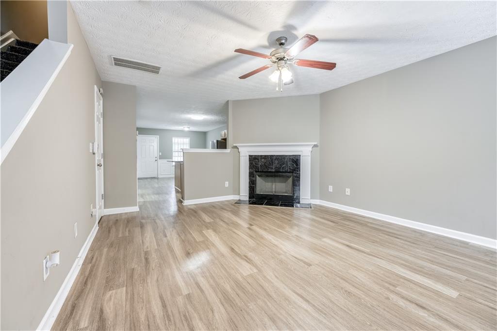 2913 Vining Ridge Terrace Decatur, GA 30034 - Photo 5 of 28 wooden floor in an empty room with a fireplace