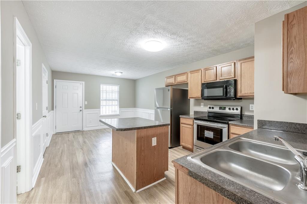 2913 Vining Ridge Terrace Decatur, GA 30034 - Photo 7 of 28 a kitchen with stainless steel appliances granite countertop a sink stove and refrigerator
