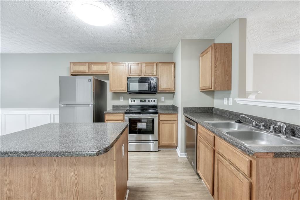 2913 Vining Ridge Terrace Decatur, GA 30034 - Photo 8 of 28 a kitchen with stainless steel appliances granite countertop a sink stove and refrigerator