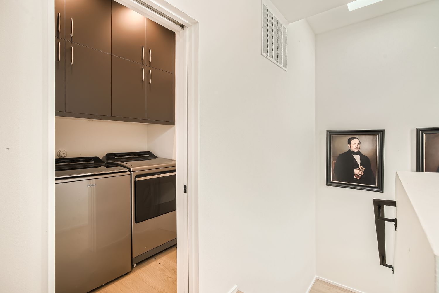 7525 Delafield Lane, Unit A Austin, TX 78752 - Photo 28 of 33 Laundry room featuring cabinet space, light wood-style floors, and washer and clothes dryer