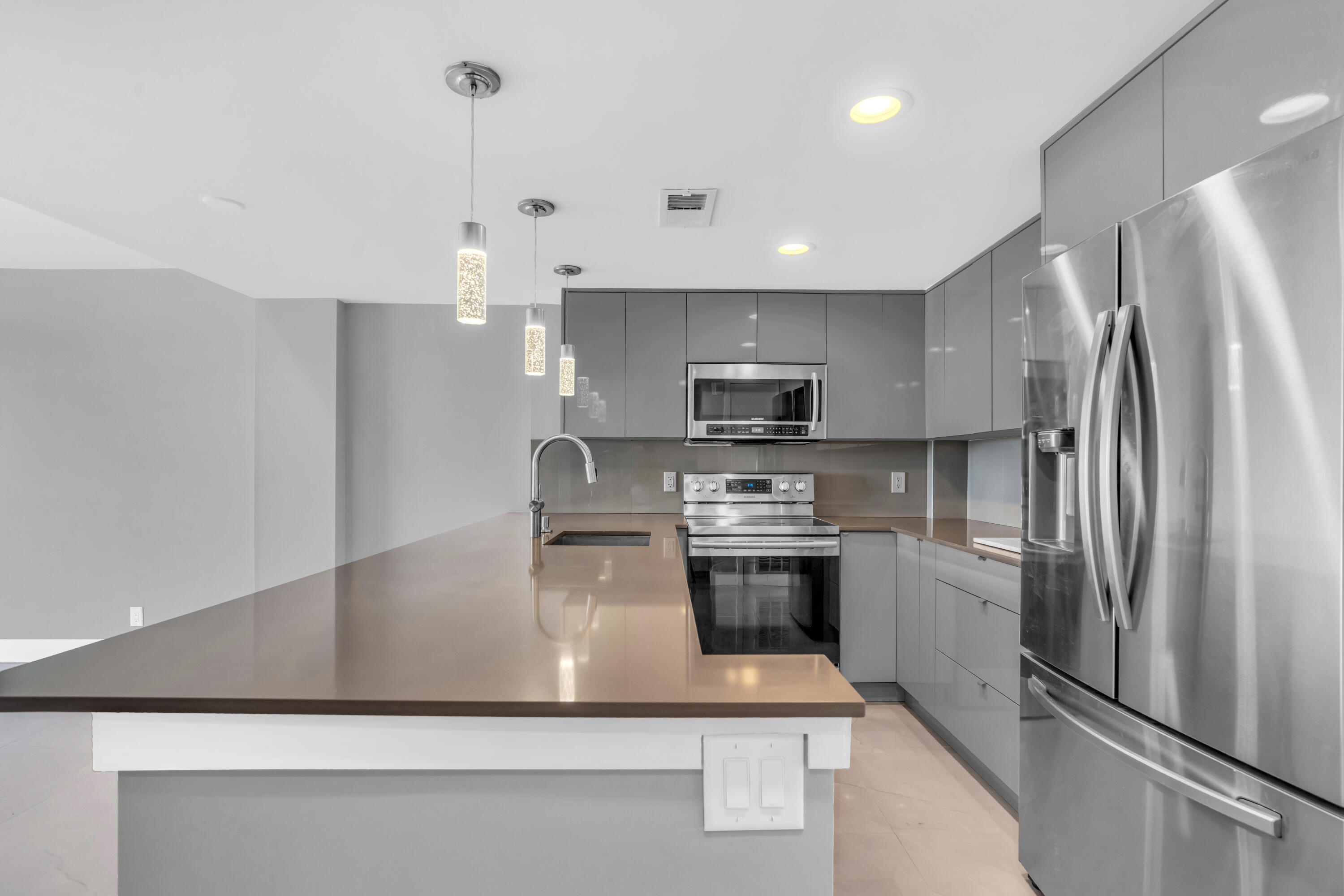 a kitchen with stainless steel appliances a refrigerator sink and stove