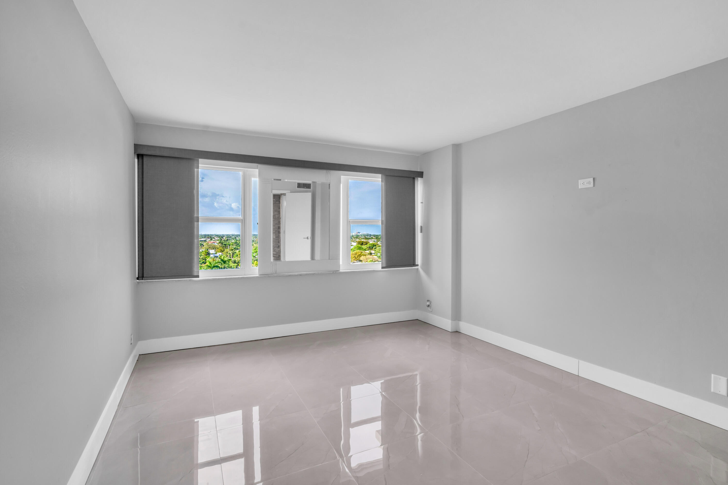 2611 North Riverside Drive, Unit 1004 Pompano Beach, FL 33062 - Photo 15 of 32 wooden floor in an empty room with a window