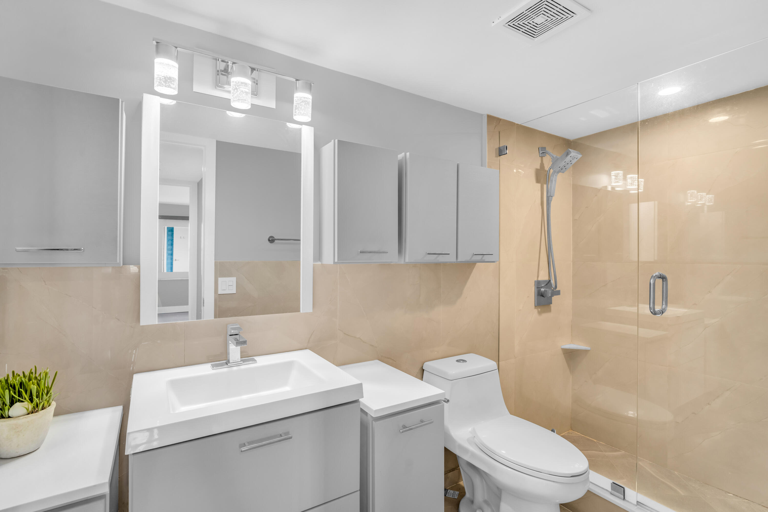 2611 North Riverside Drive, Unit 1004 Pompano Beach, FL 33062 - Photo 18 of 32 a bathroom with a sink toilet vanity and shower