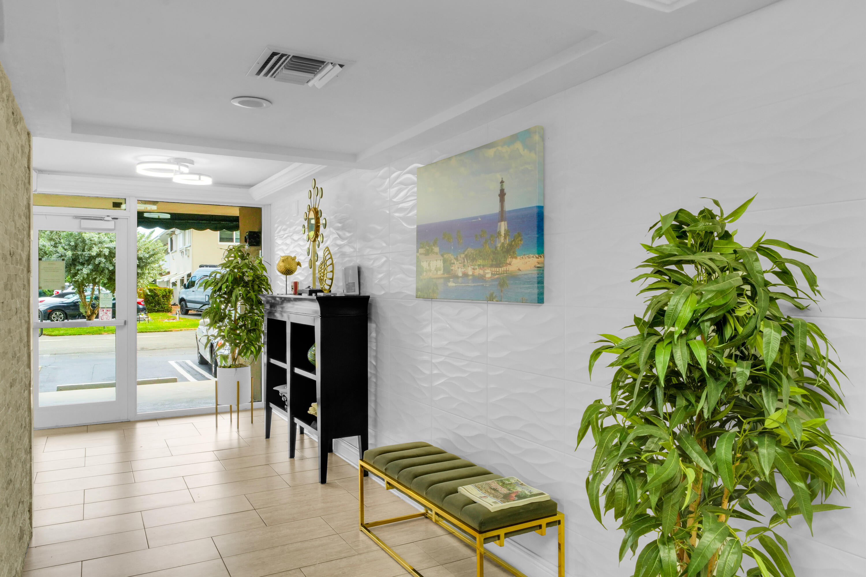 2611 North Riverside Drive, Unit 1004 Pompano Beach, FL 33062 - Photo 21 of 32 a living room with furniture and a potted plant